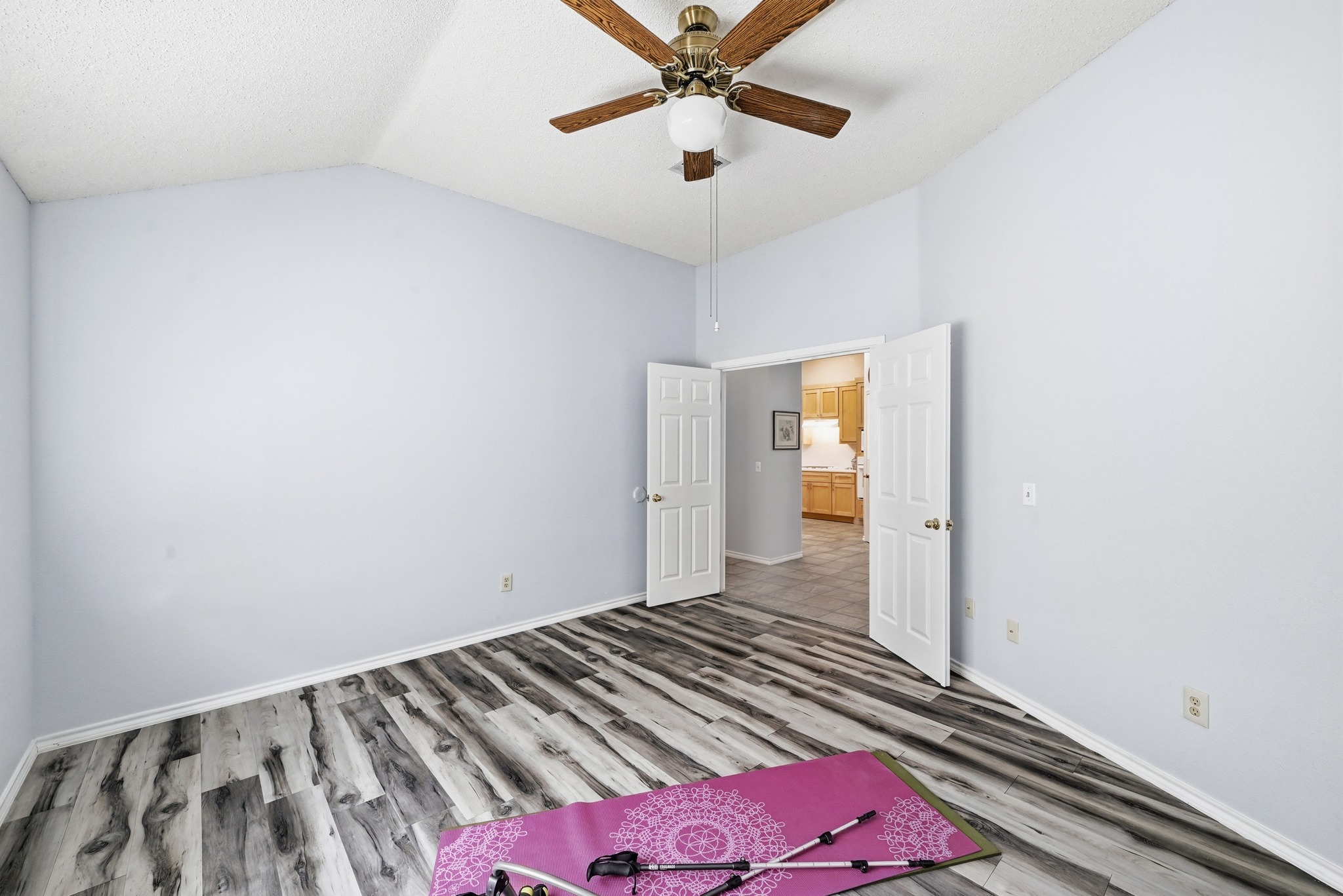 10803 Pinkney Lane Austin, TX 78739 - Photo 21 of 38 Unfurnished bedroom featuring vaulted ceiling, light wood-style floors, and ceiling fan