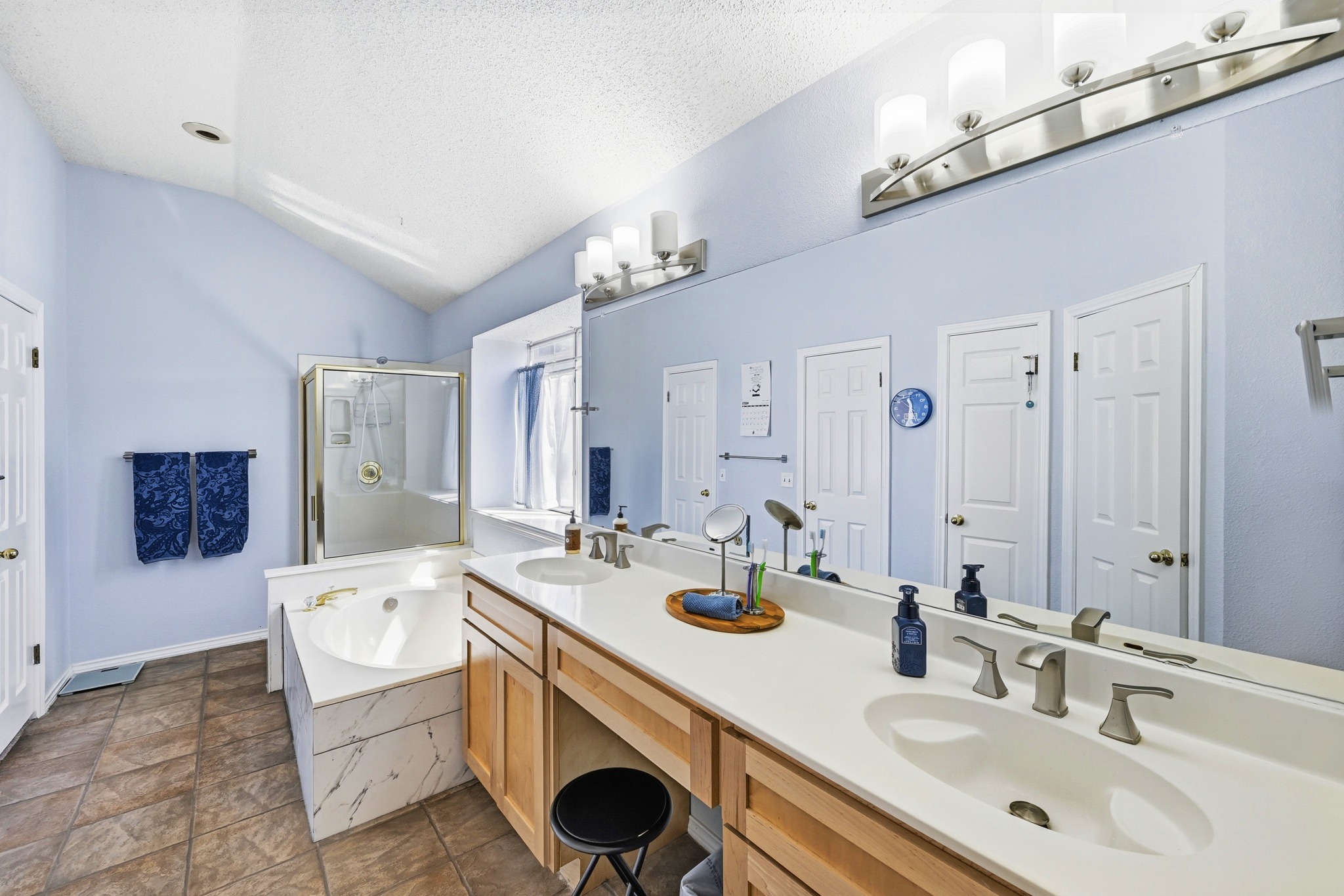 10803 Pinkney Lane Austin, TX 78739 - Photo 24 of 38 Bathroom featuring a shower stall, double vanity, and a garden tub