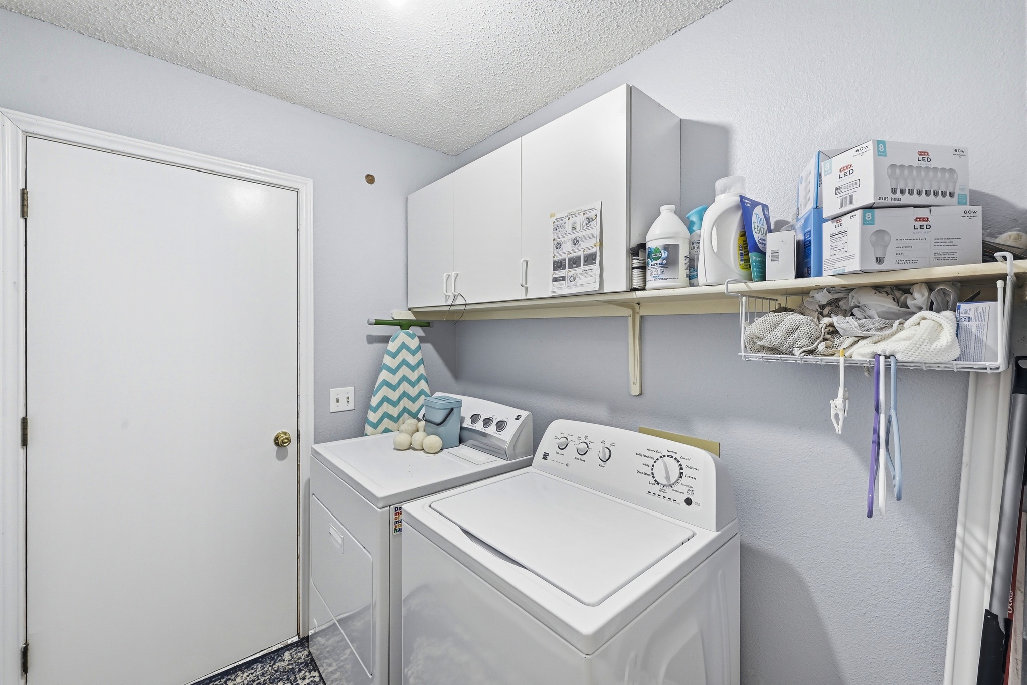 10803 Pinkney Lane Austin, TX 78739 - Photo 30 of 38 Laundry area featuring a textured ceiling, washer and dryer, and cabinet space