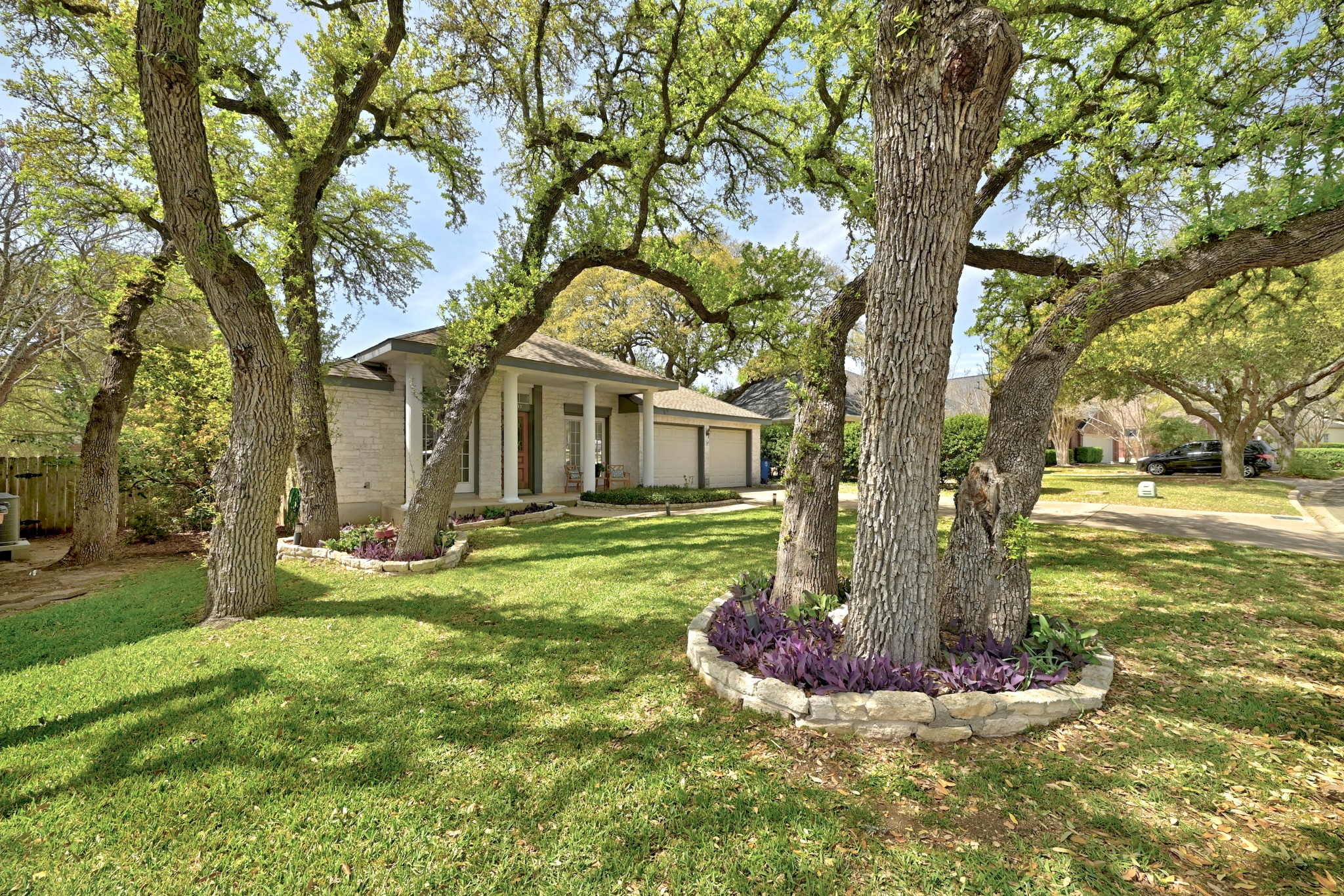10803 Pinkney Lane Austin, TX 78739 - Photo 3 of 38 View of front of house with a porch, brick siding, and a garage