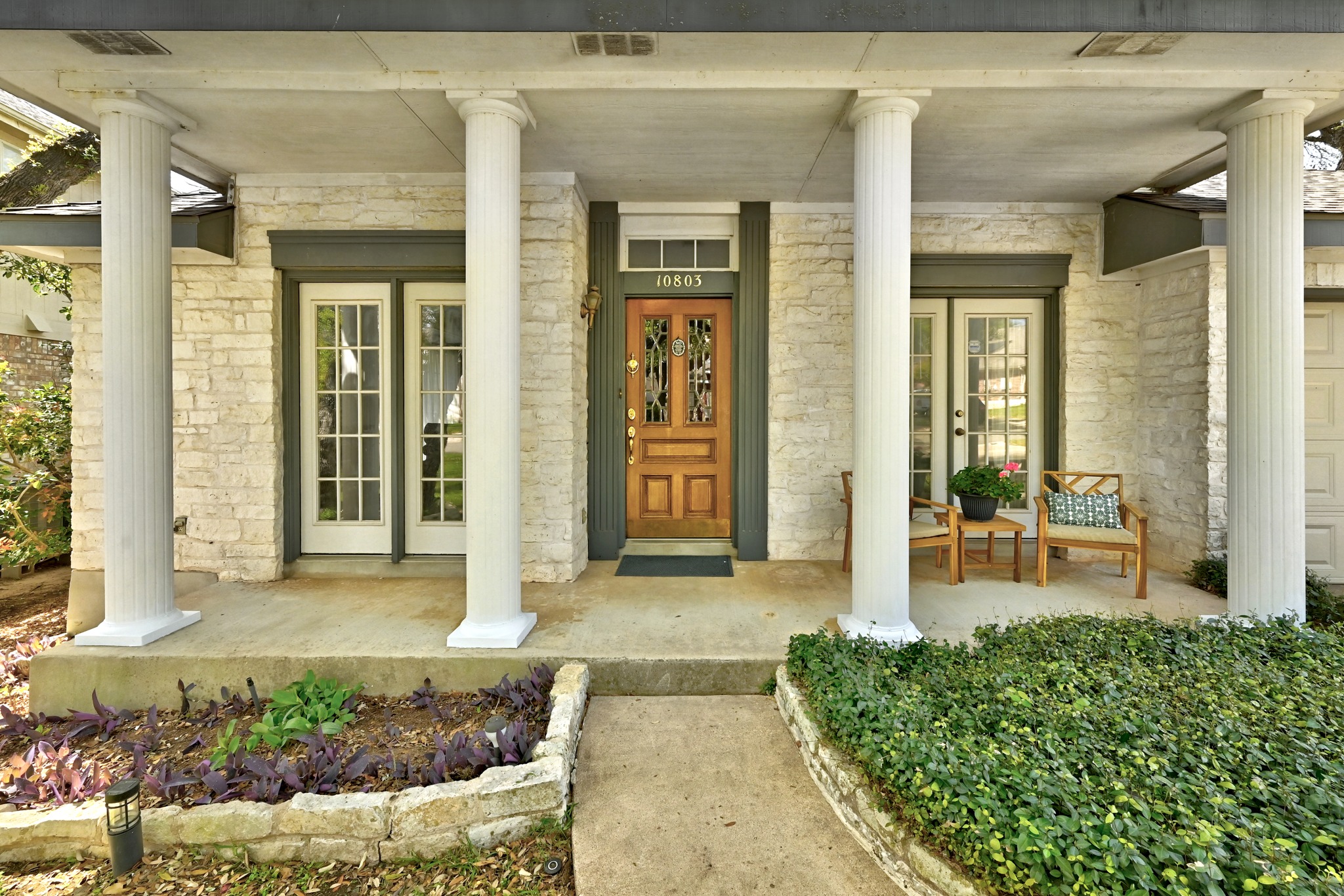 10803 Pinkney Lane Austin, TX 78739 - Photo 4 of 38 Doorway to property featuring stone siding, covered porch, and french doors