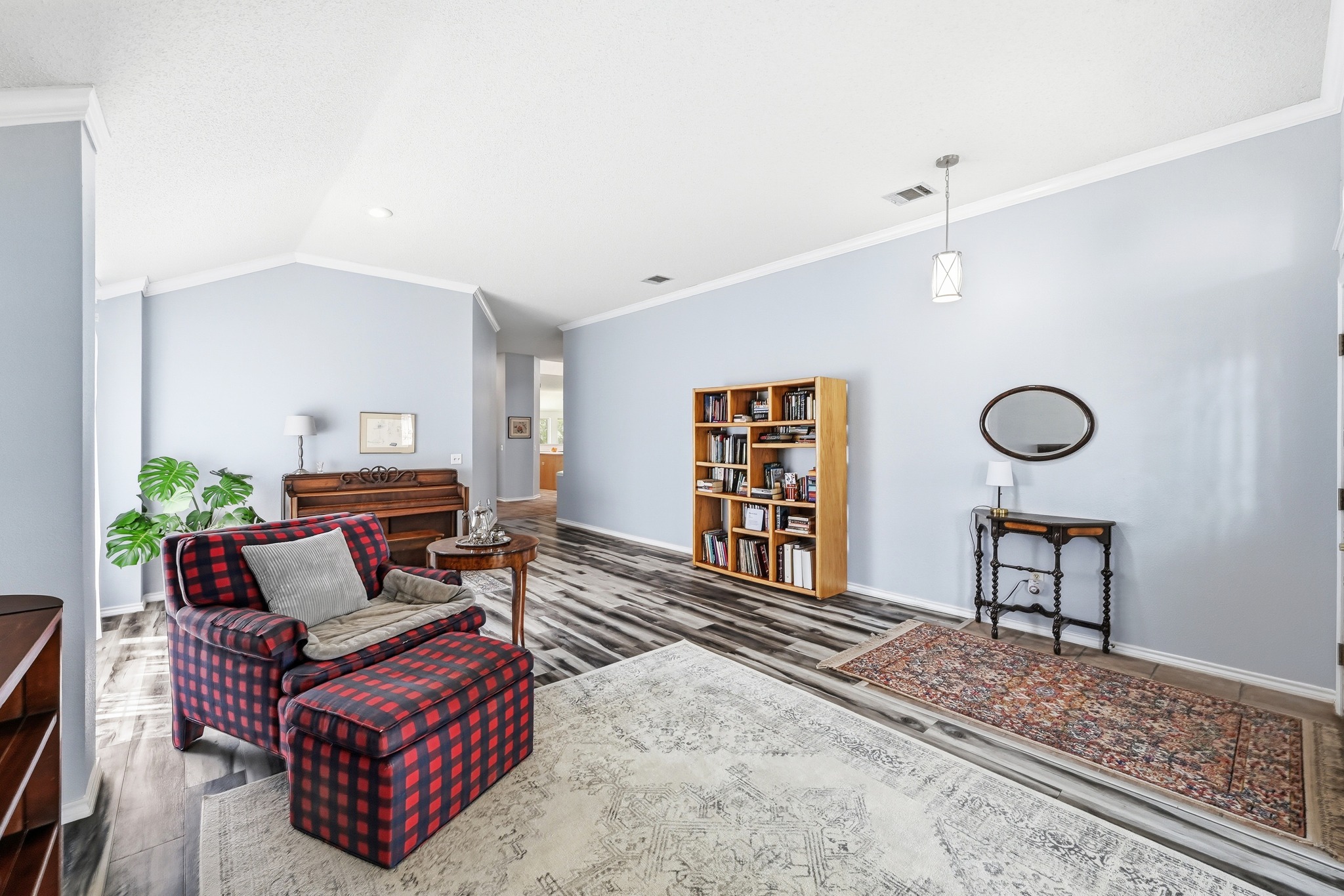 10803 Pinkney Lane Austin, TX 78739 - Photo 5 of 38 Living area featuring ornamental molding, vaulted ceiling, and dark wood-style flooring