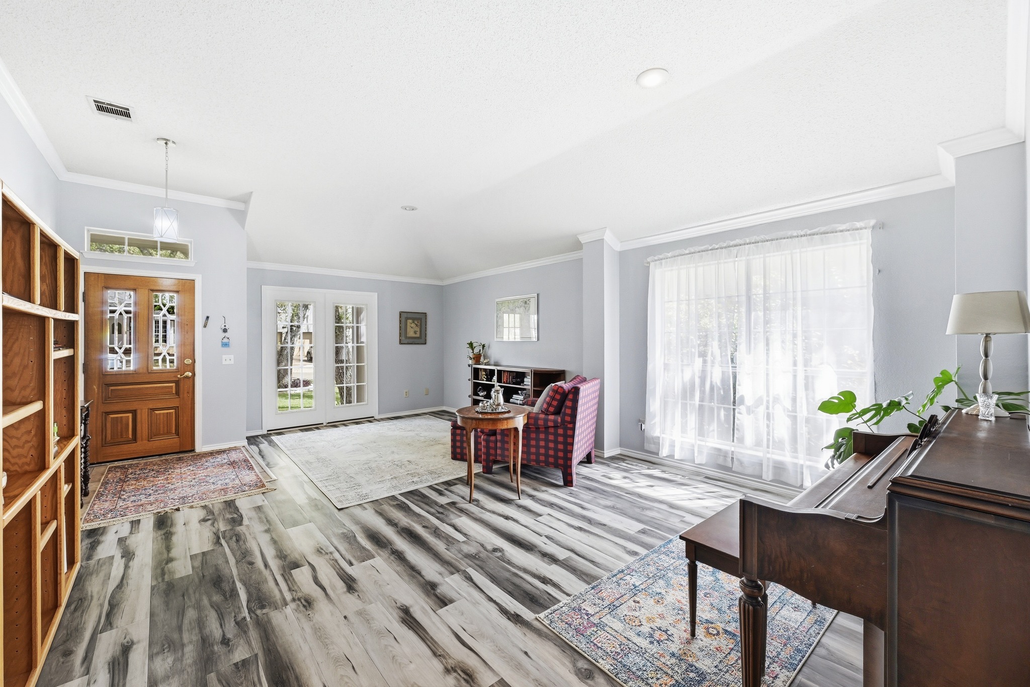 10803 Pinkney Lane Austin, TX 78739 - Photo 7 of 38 Foyer featuring ornamental molding, lofted ceiling, and light wood-style flooring