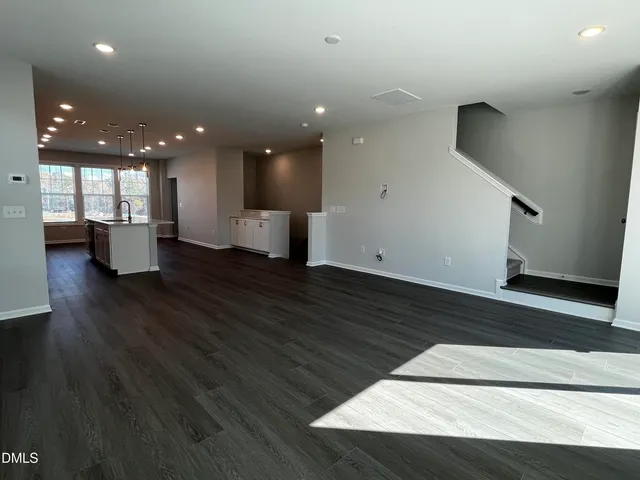 a view of kitchen and hall with wooden floor