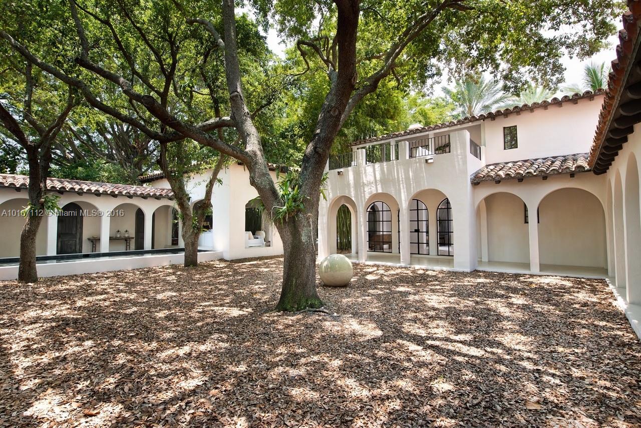 4452 North Bay Road Miami Beach, FL 33140 - Photo 3 of 17 a white house with a large tree in front of it