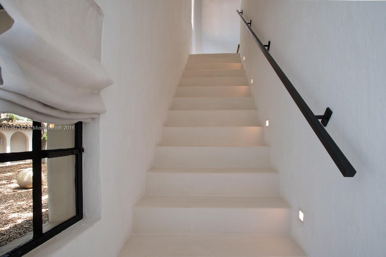 4452 North Bay Road Miami Beach, FL 33140 - Photo 8 of 17 a view of staircase with lots of frames on wall