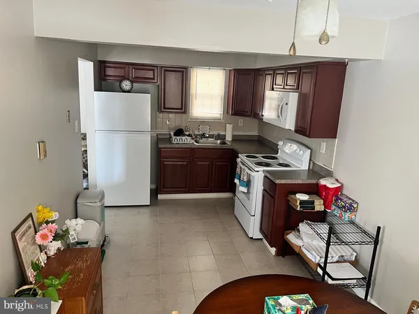a kitchen with stainless steel appliances granite countertop a refrigerator sink and cabinets