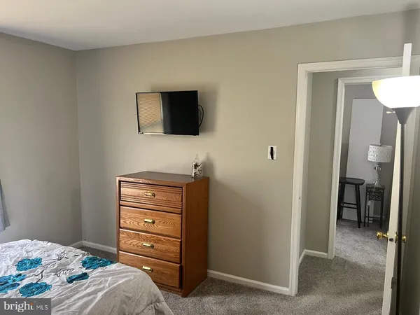 a bedroom with a bed and a television