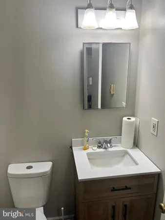 a bathroom with a toilet sink and mirror