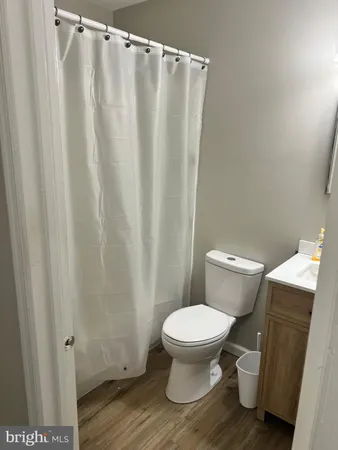 a white toilet sitting next to a shower curtain
