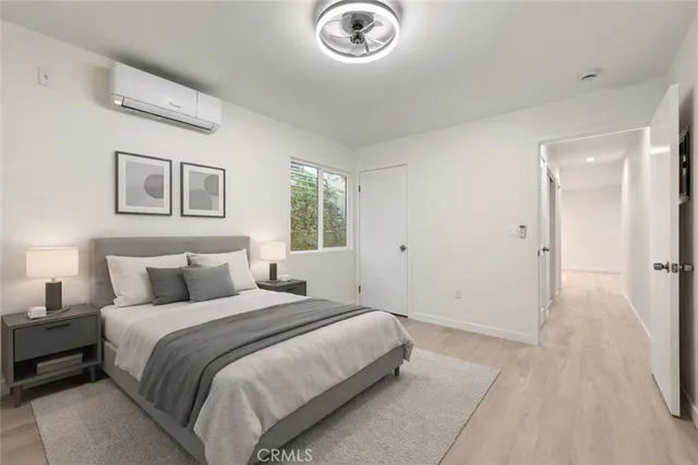 a bedroom with a bed and a chandelier