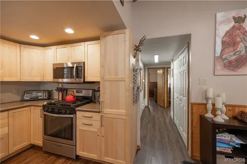 a kitchen with stainless steel appliances white cabinets and a refrigerator