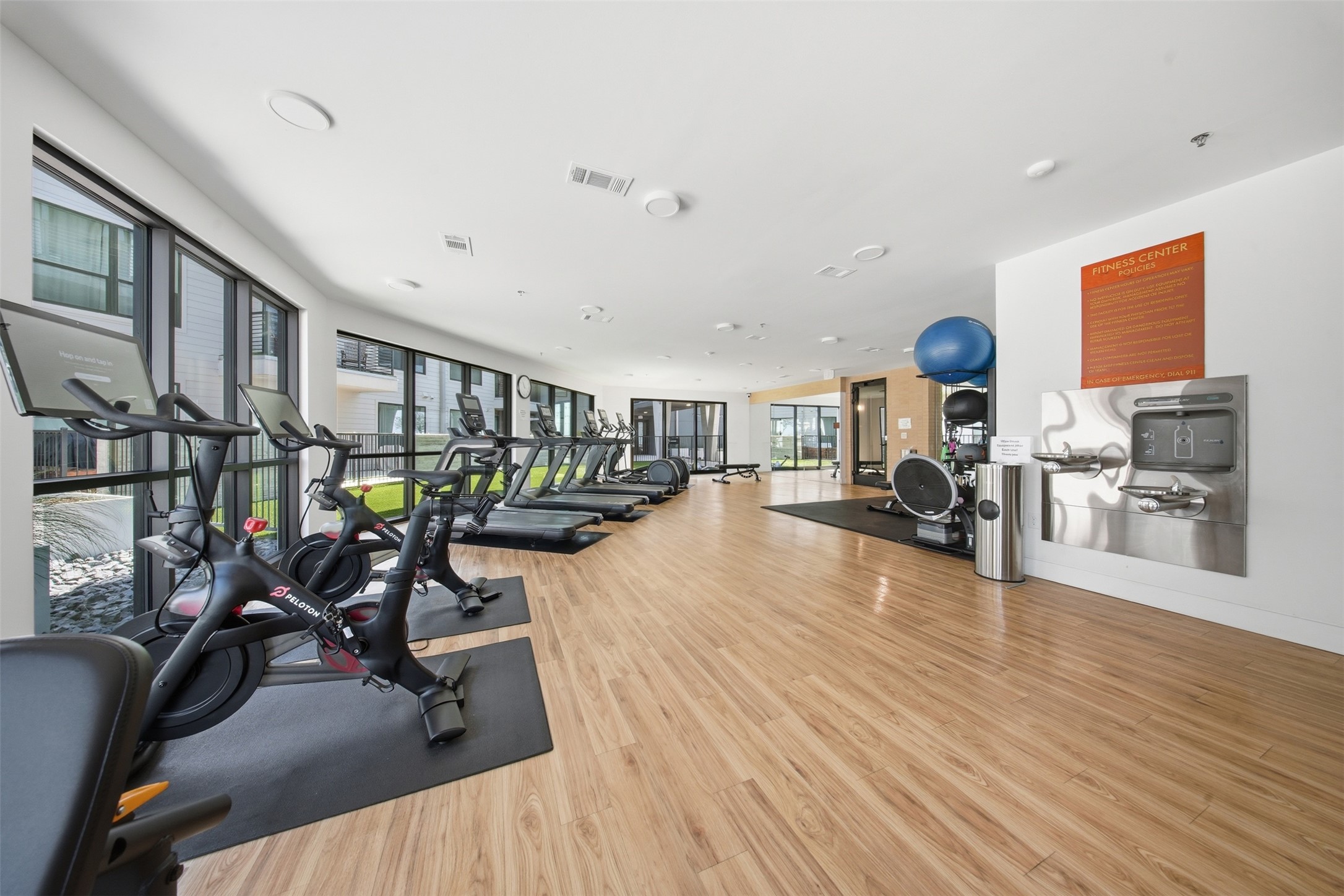 1701 Simond Avenue, Unit 615 Austin, TX 78723 - Photo 15 of 25 Fitness center featuring wood-finish flooring and extensive natural light from large windows
