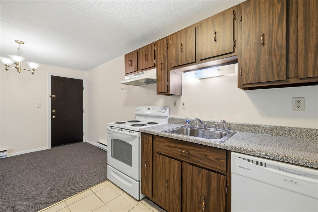 80 Damon Road, Unit 2303 Northampton, MA 01060 - Photo 10 of 23 a kitchen with stainless steel appliances granite countertop a sink stove and cabinets
