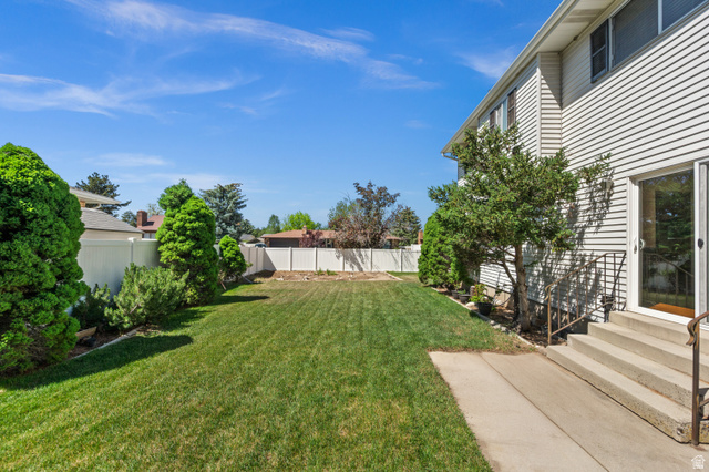 1650 Nichole Circle Sandy, UT 84093 - Photo 27 of 31 Expansive grassy yard area with a white privacy fence