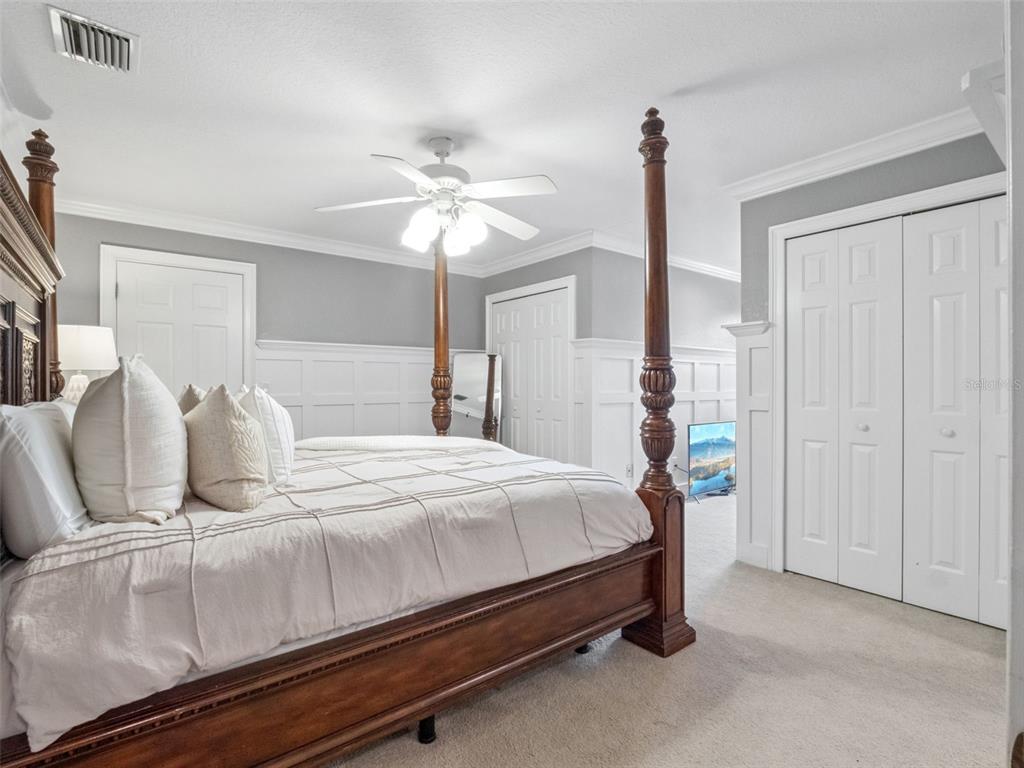 2509 Ridgewind Way Windermere, FL 34786 - Photo 18 of 39 a bedroom with a bed and a chandelier