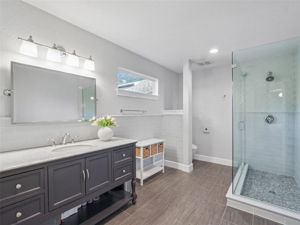2509 Ridgewind Way Windermere, FL 34786 - Photo 19 of 39 a spacious bathroom with a double vanity sink mirror and shower