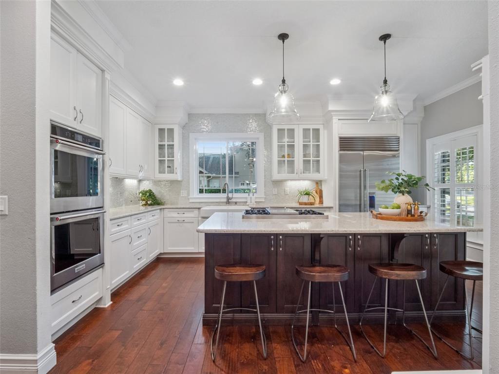 2509 Ridgewind Way Windermere, FL 34786 - Photo 2 of 39 a kitchen with a dining table chairs stainless steel appliances and cabinets