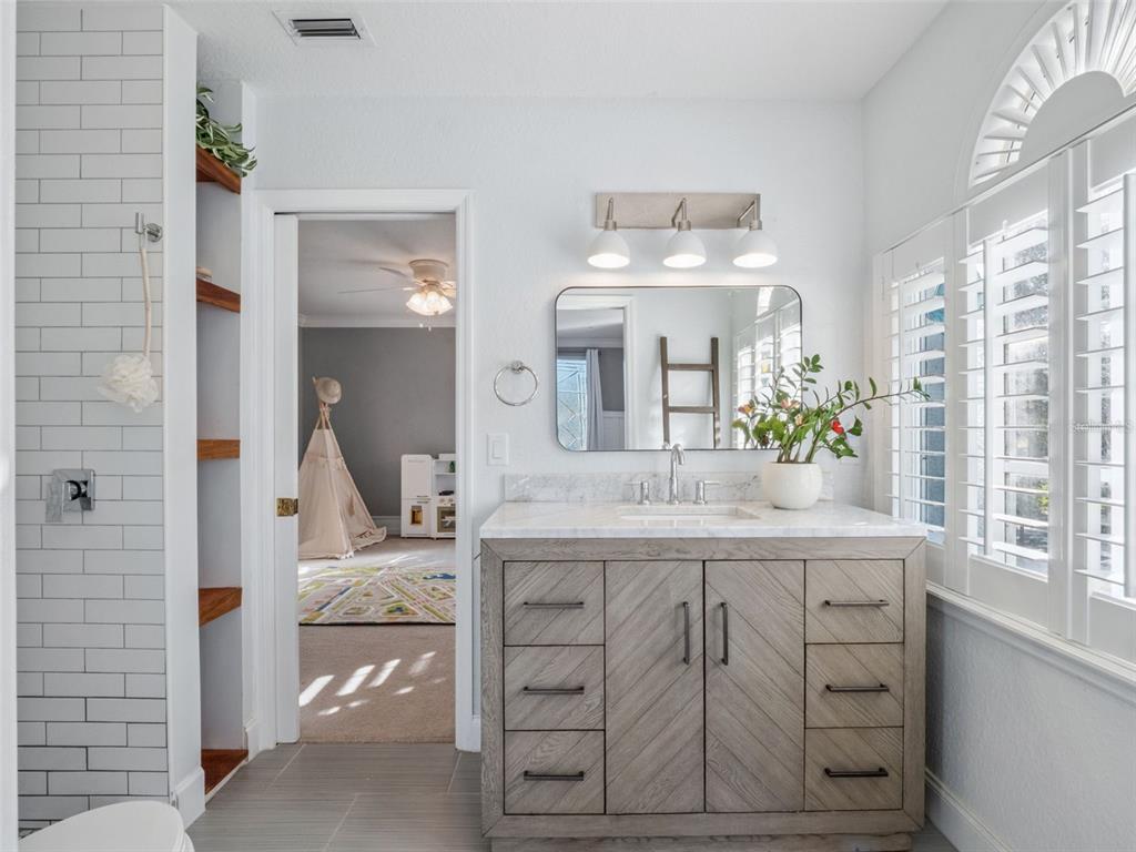 2509 Ridgewind Way Windermere, FL 34786 - Photo 23 of 39 a bathroom with a sink a vanity and mirror