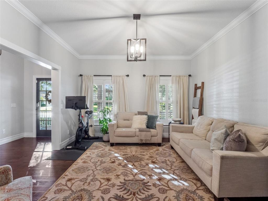 2509 Ridgewind Way Windermere, FL 34786 - Photo 8 of 39 a living room with furniture chandelier and wooden floor