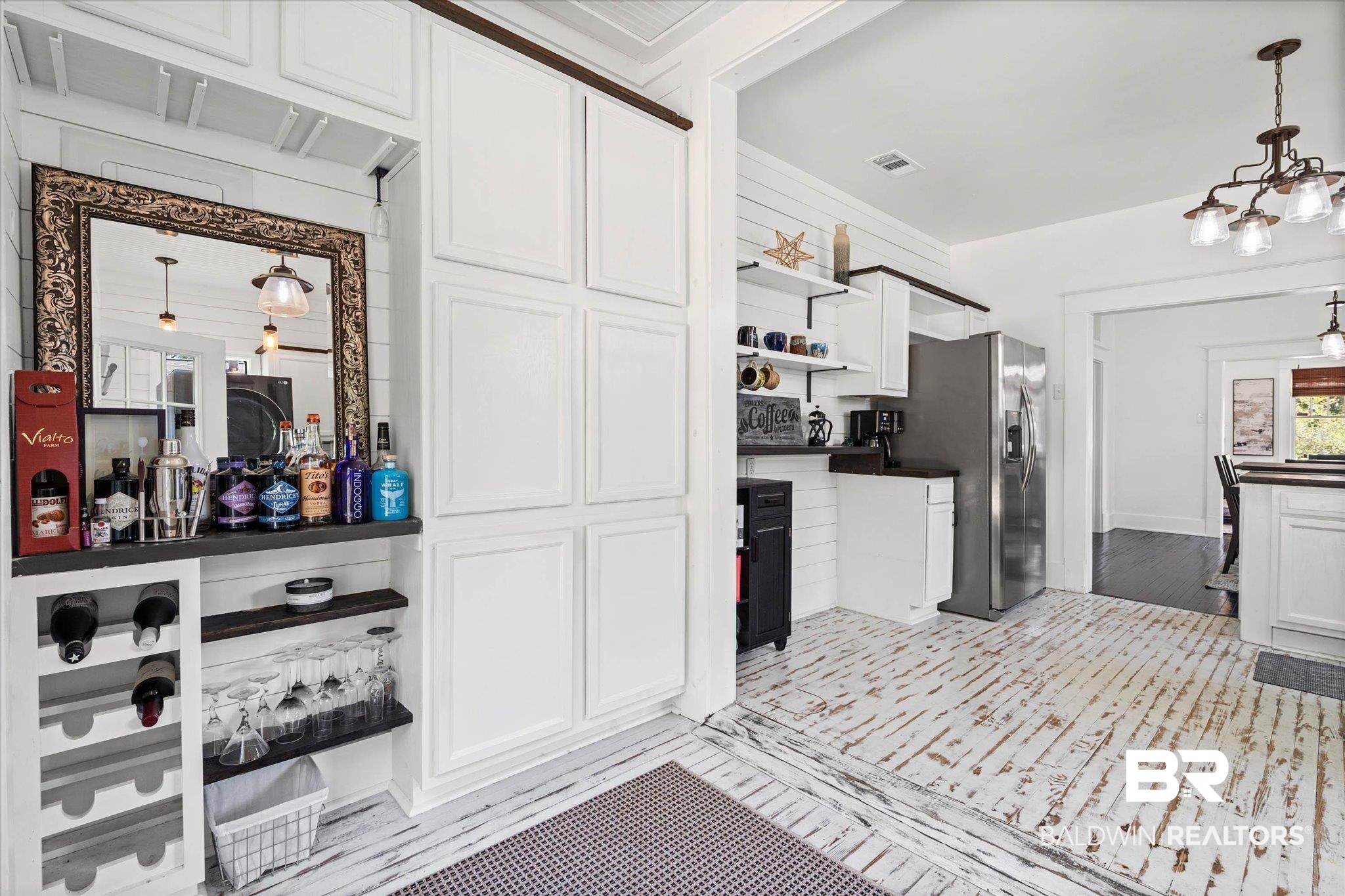 121 North Carlen Street Mobile, AL 36607 - Photo 16 of 21 Featuring white cabinetry, dark countertops, open shelves, stainless steel fridge with ice dispenser, and a chandelier