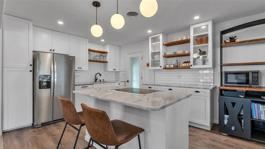 835 Chatfield Street Lakeland, FL 33803 - Photo 12 of 54 a kitchen with stainless steel appliances granite countertop a sink a stove and a refrigerator