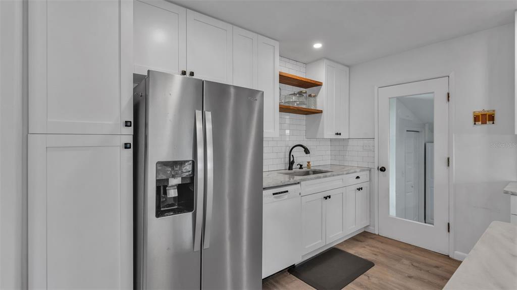 835 Chatfield Street Lakeland, FL 33803 - Photo 19 of 54 a kitchen with stainless steel appliances a refrigerator a sink and cabinets