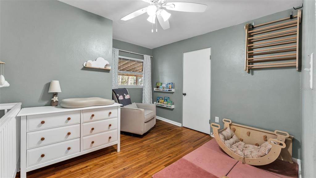 835 Chatfield Street Lakeland, FL 33803 - Photo 25 of 54 a bedroom with a bed and wooden floor