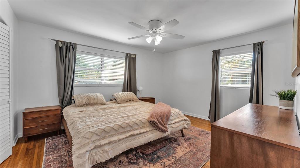 835 Chatfield Street Lakeland, FL 33803 - Photo 30 of 54 a bedroom with a large bed and a chandelier