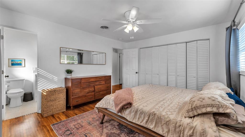 835 Chatfield Street Lakeland, FL 33803 - Photo 31 of 54 a bedroom with a bed and a chandelier