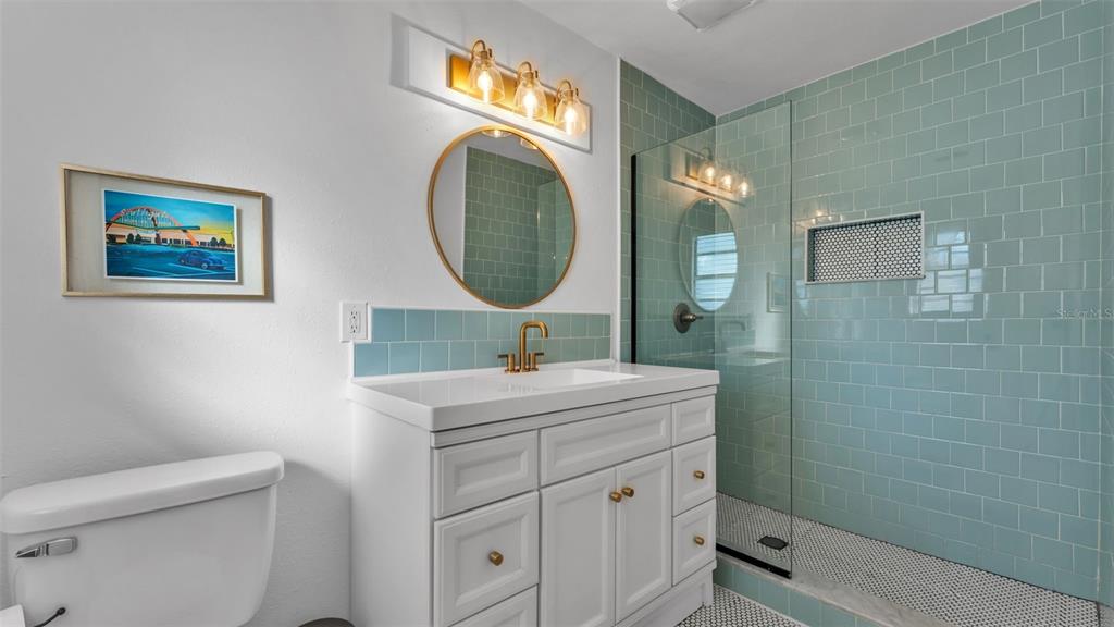 835 Chatfield Street Lakeland, FL 33803 - Photo 33 of 54 a bathroom with a sink mirror vanity and toilet