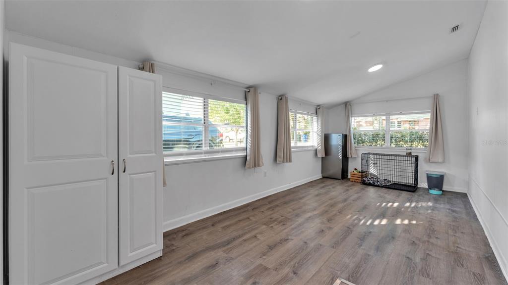 835 Chatfield Street Lakeland, FL 33803 - Photo 39 of 54 a view of an empty room with wooden floor and a window
