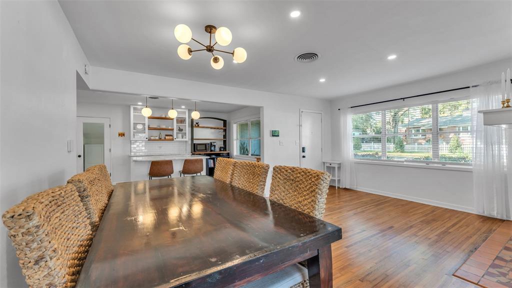 835 Chatfield Street Lakeland, FL 33803 - Photo 9 of 54 a view of a dining room and livingroom with furniture wooden floor a chandelier
