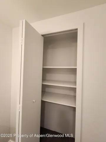 a view of an empty room with a window