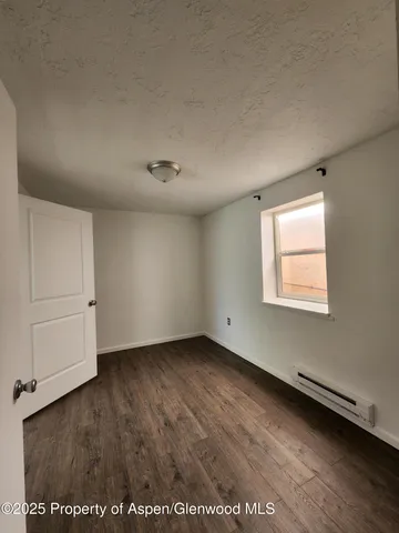an empty room with a empty space and windows