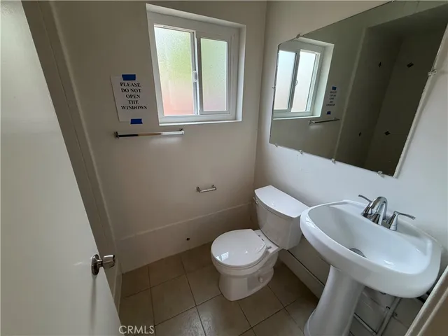 a white toilet sitting next to a bathroom sink