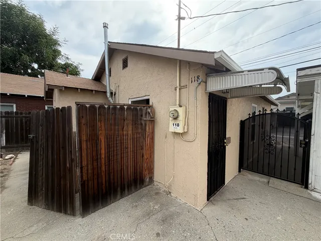 a view of a house with wooden fence