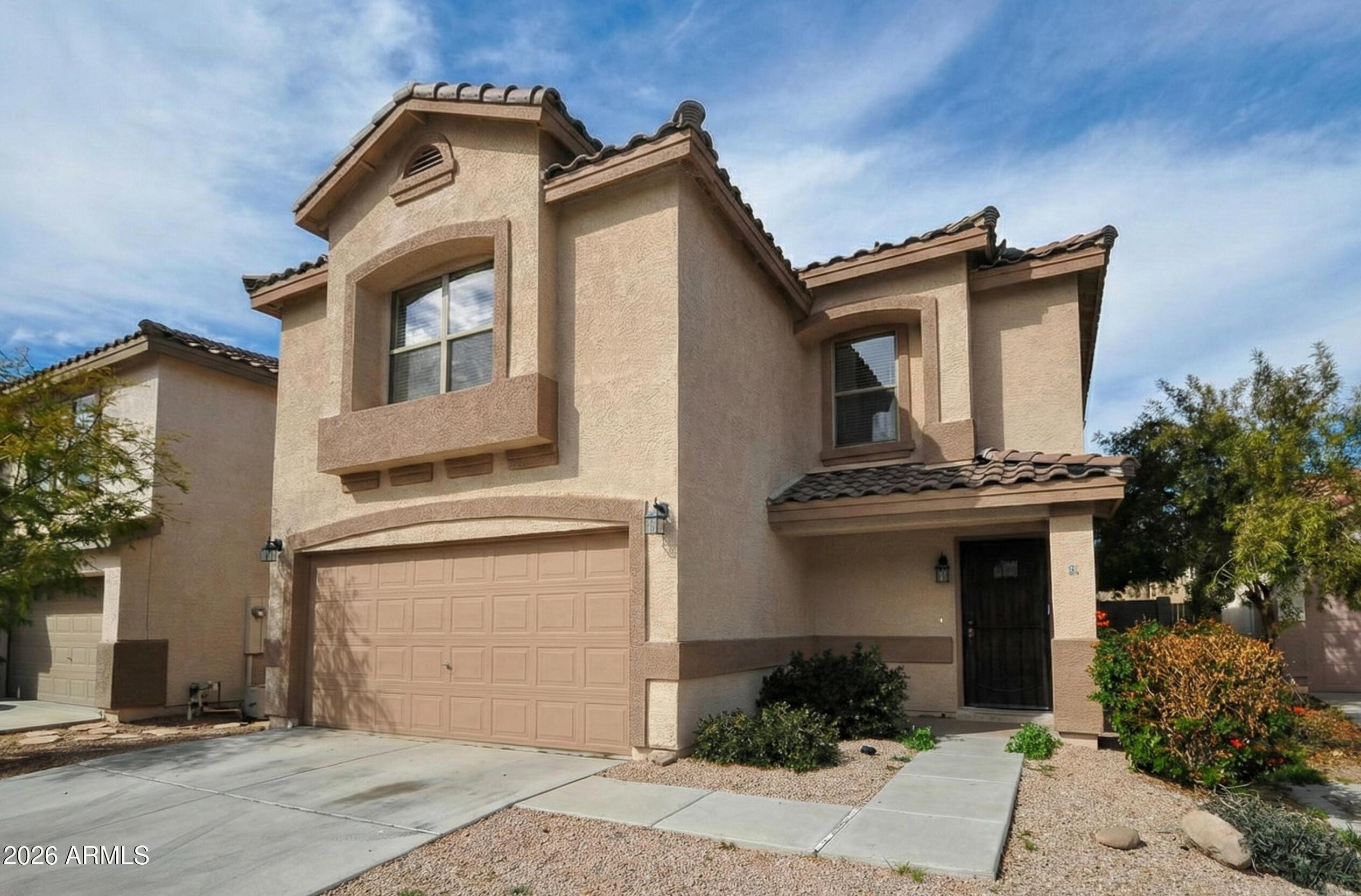 3331 South Chaparral Road Apache Junction, AZ 85119 - Photo 2 of 24 a front view of a house with a garden
