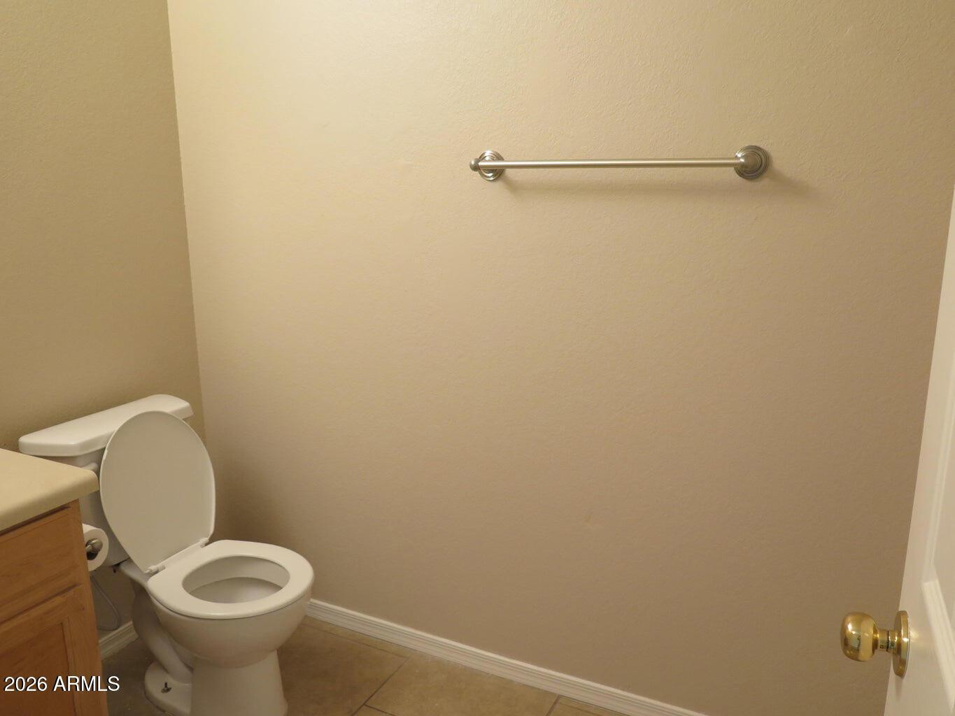 3331 South Chaparral Road Apache Junction, AZ 85119 - Photo 9 of 24 a white toilet sitting in a bathroom next to a sink
