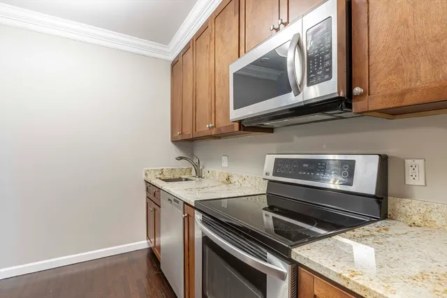 a living room with a flat screen tv and a refrigerator