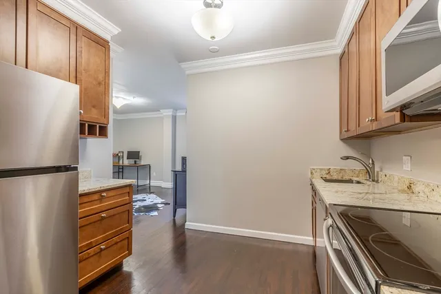 a kitchen with stainless steel appliances a refrigerator and a stove