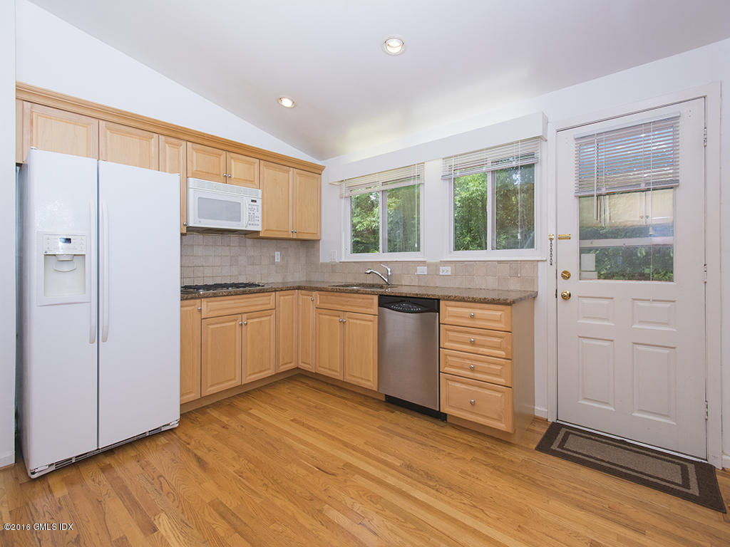 6 Crawford Terrace Riverside, CT 06878 - Photo 11 of 29 a kitchen with granite countertop white cabinets and white appliances