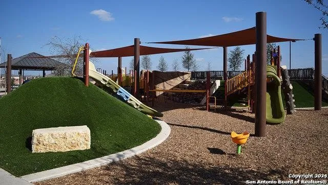 a view of a house with backyard patio and swimming pool