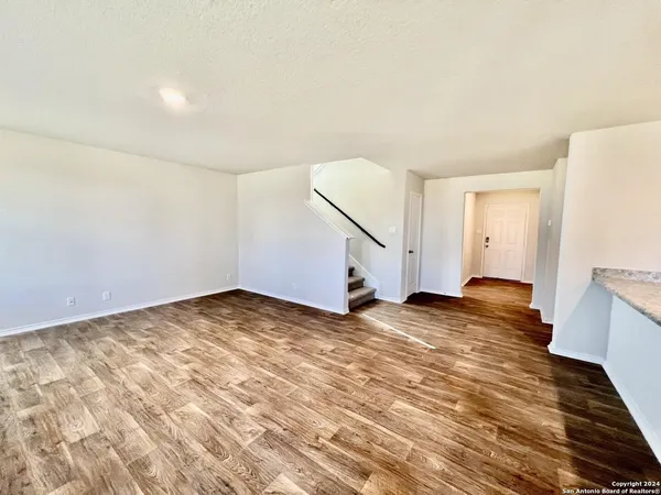 a view of a room with wooden floor and a sink
