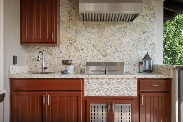 a kitchen with a sink and a wooden cabinets