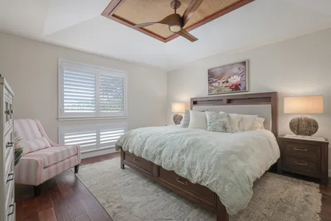 a bedroom with a bed a couch and window