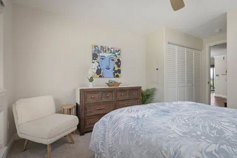 a view of staircase with wooden floor and fan