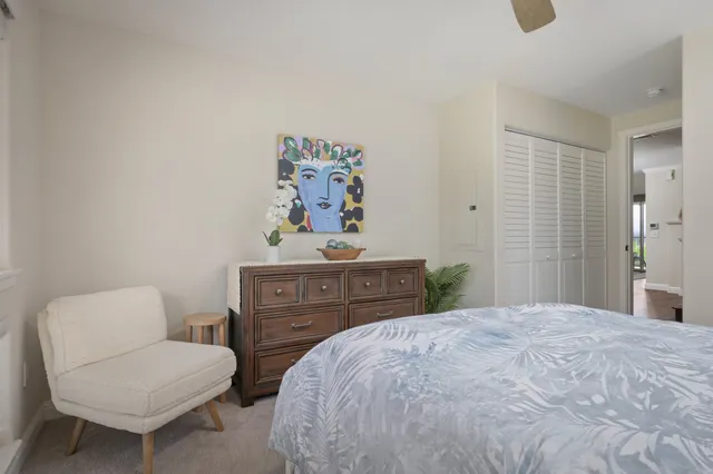 a view of staircase with wooden floor and fan