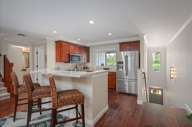 a kitchen with refrigerator cabinets and wooden floor