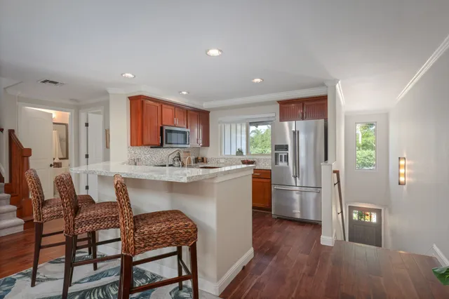 a kitchen with refrigerator cabinets and wooden floor